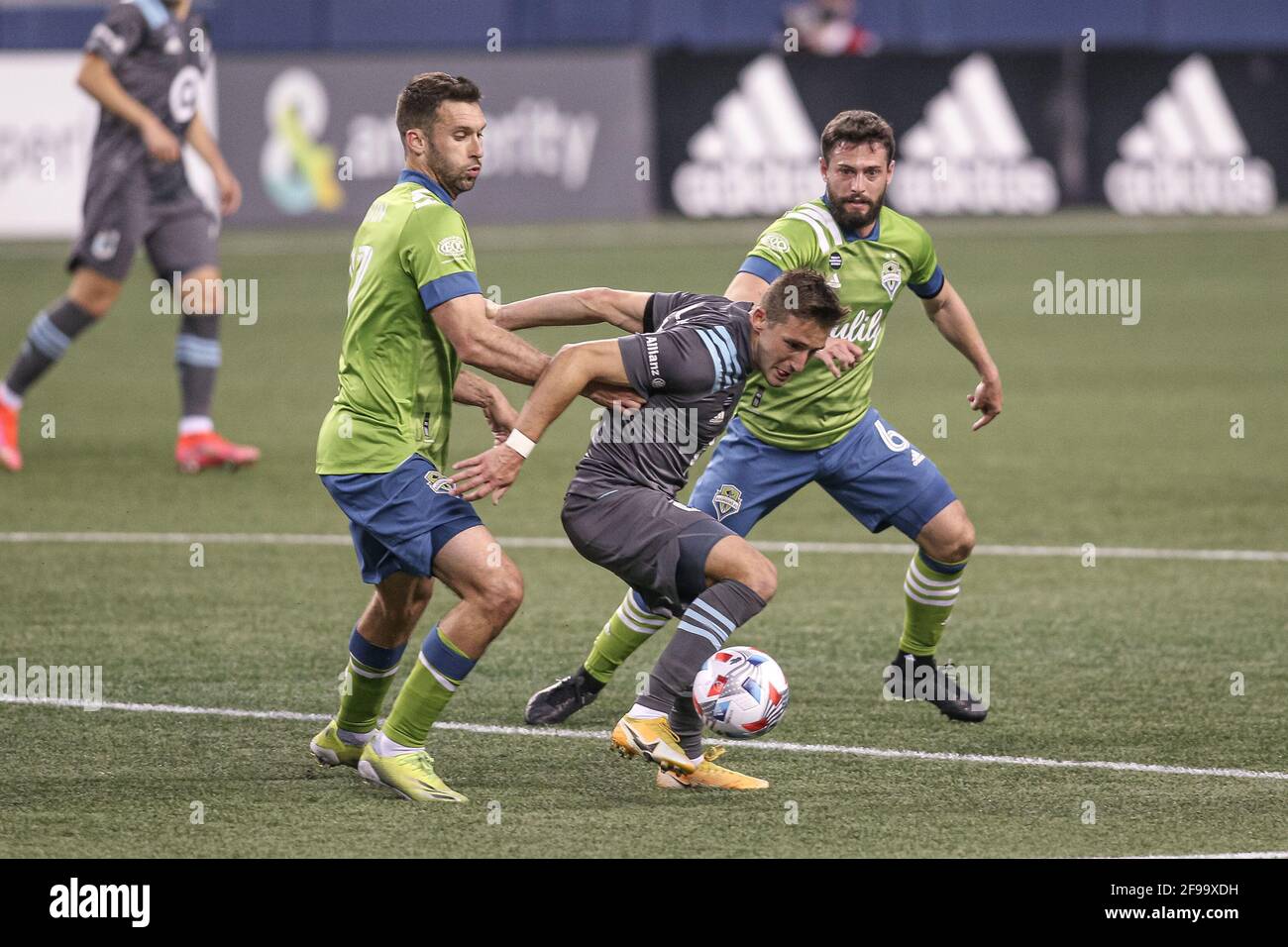Minnesota United FC midfielder Ethan Finlay (13) with the ball against Seattle Sounders FC midfielder Joao Paulo (6) and defender Will Bruin (17) duri Stock Photo