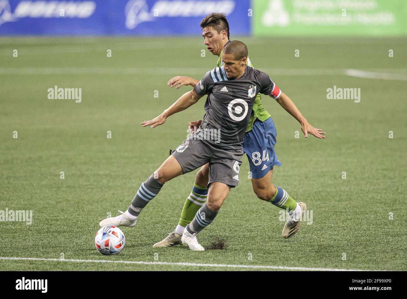 Minnesota United FC midfielder Osvaldo Alonso (6) and Seattle Sounders FC midfielder Josh Atencio (84) battle for the ball during the second half of a Stock Photo