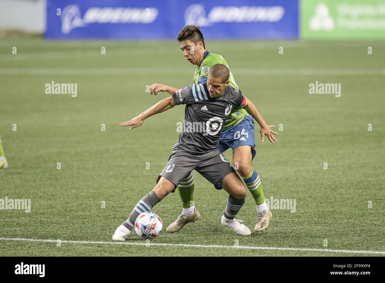 Minnesota United FC midfielder Osvaldo Alonso (6) and Seattle Sounders FC midfielder Josh Atencio (84) battle for the ball during the second half of a Stock Photo