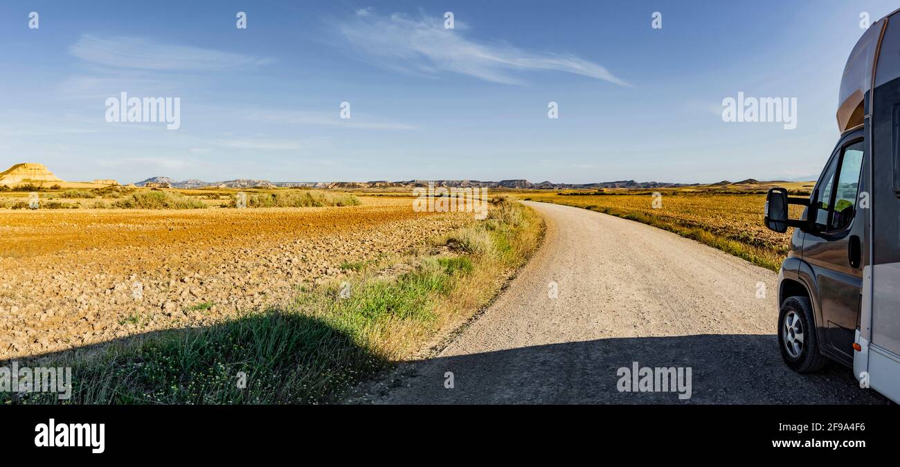 Motorhome on a dust road in a desert landscape Stock Photo