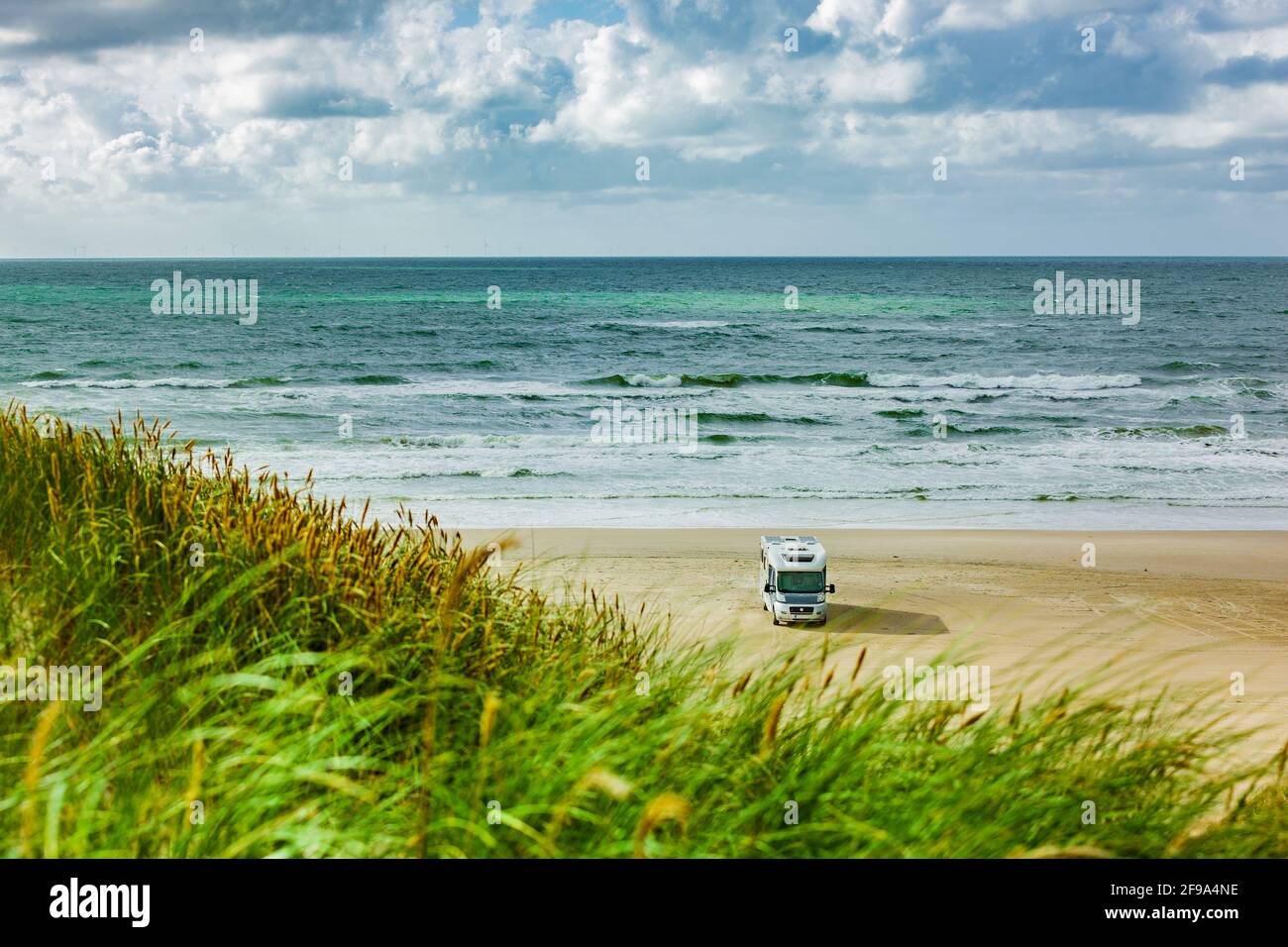 Motorhome on a sandy beach by the sea Stock Photo