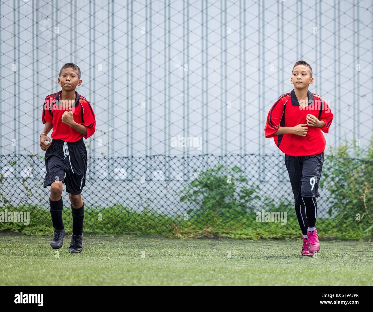 Boy Football Player training session running exercise for Children