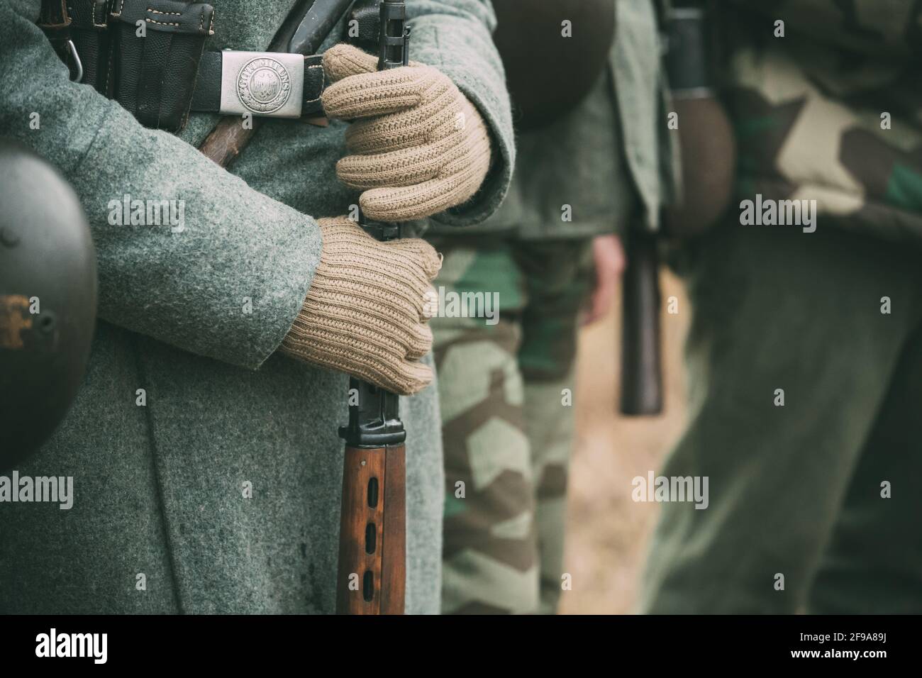 Close Up Of German Military Ammunition Of A German Wehrmacht Soldier. Re-enactors Dressed As World War II German Soldiers Standing Order. Soldier Of Stock Photo