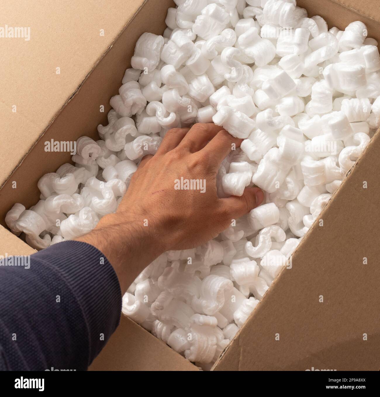 A cardboard box with packing styro foam pellets top view Stock Photo Alamy