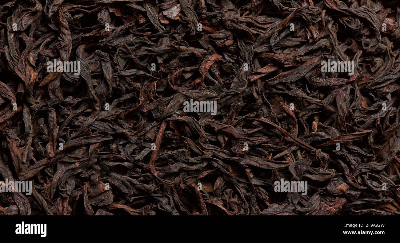 The texture of selected black tea leaves as a background Stock Photo