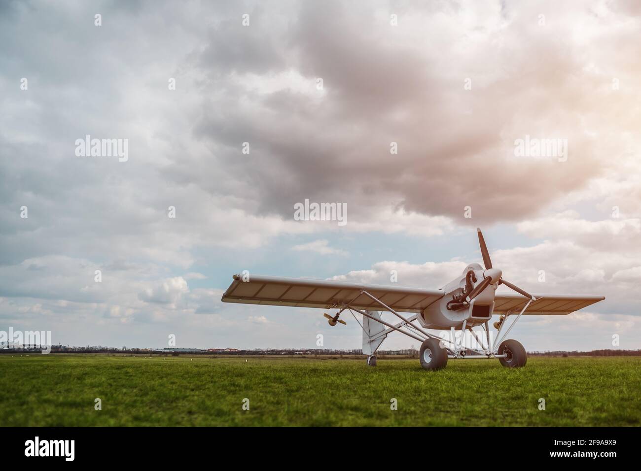remote controlled agriculture spaying air plane in field at sunset, no people Stock Photo