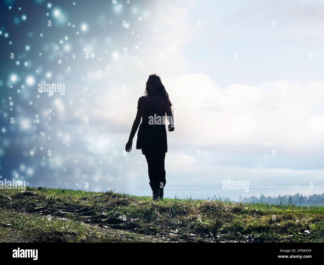 Young woman with long hair in the weather change from snow showers to sunshine Stock Photo