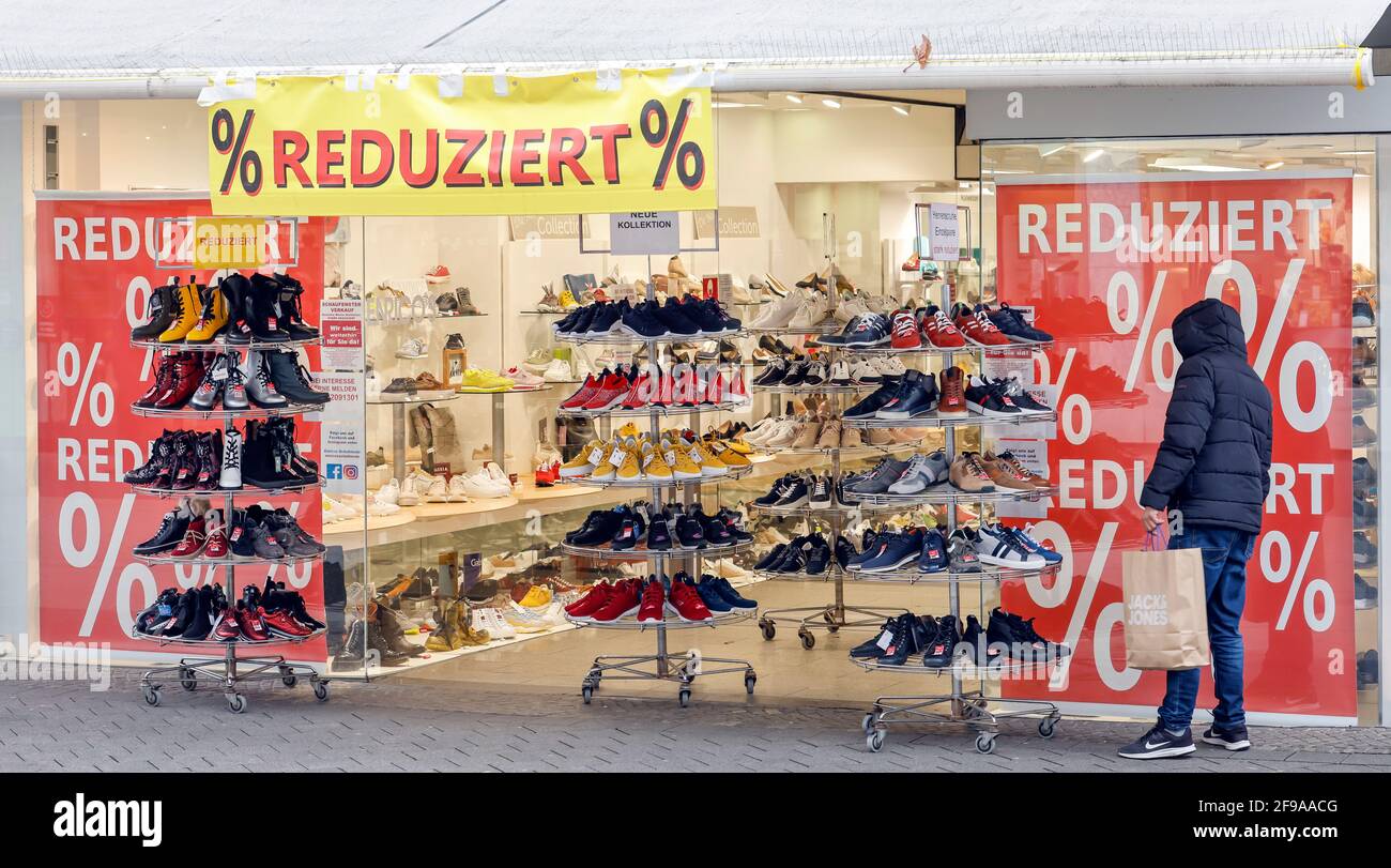 Düren, North Rhine-Westphalia, Germany - Düren city center in times of the corona crisis with the second lockdown, most shops are closed, few passers-by in the pedestrian zone, a shoe shop offers Sofort Click & Meet, register immediately and shop immediately. Stock Photo