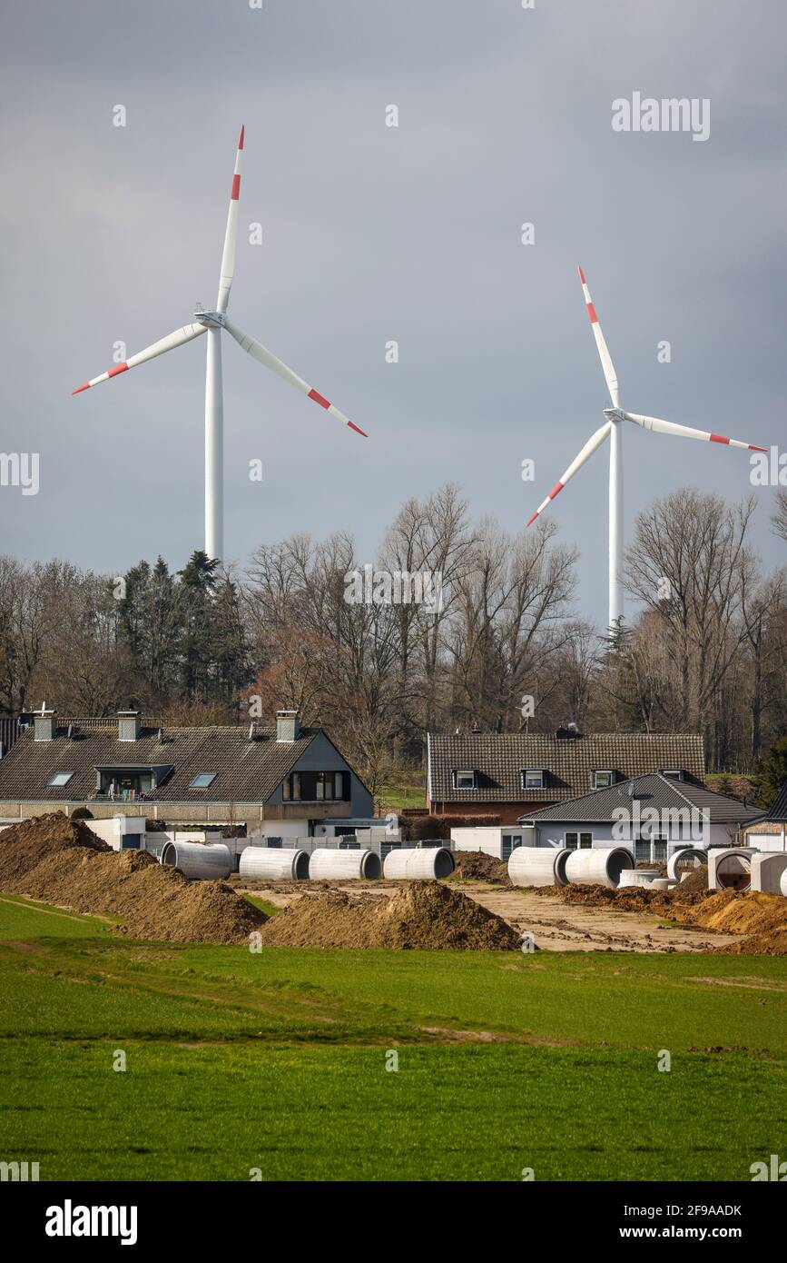Juchen, North Rhine-Westphalia, Germany - Sewer construction in a new housing estate in front of the wind farm at the RWE open-cast lignite mine in Garzweiler. Stock Photo