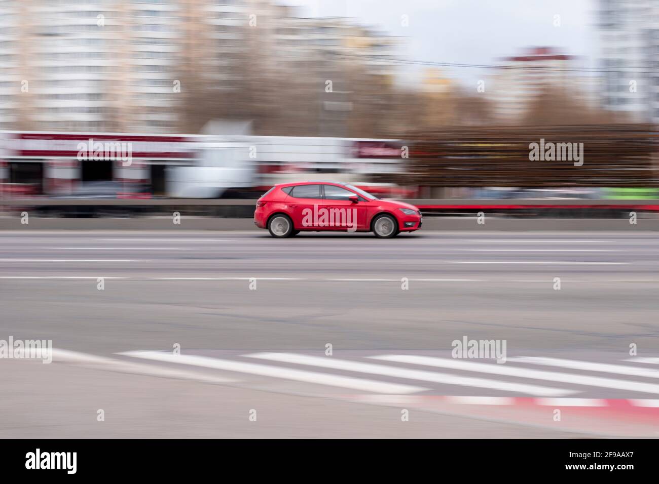 Ukraine, Kyiv - 18 March 2021: Red Seat Leon car moving on the street. Editorial Stock Photo