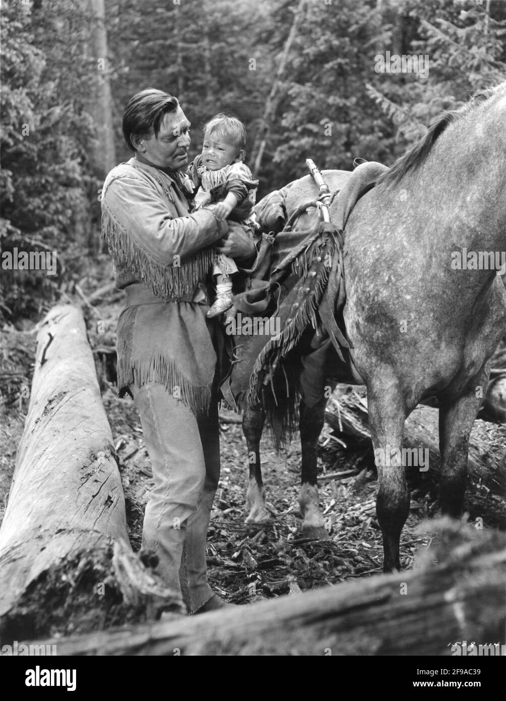 CLARK GABLE and Baby in ACROSS THE WIDE MISSOURI 1951 director WILLIAM A. WELLMAN screenplay Talbot Jennings book Bernard DeVoto Metro Goldwyn Mayer Stock Photo