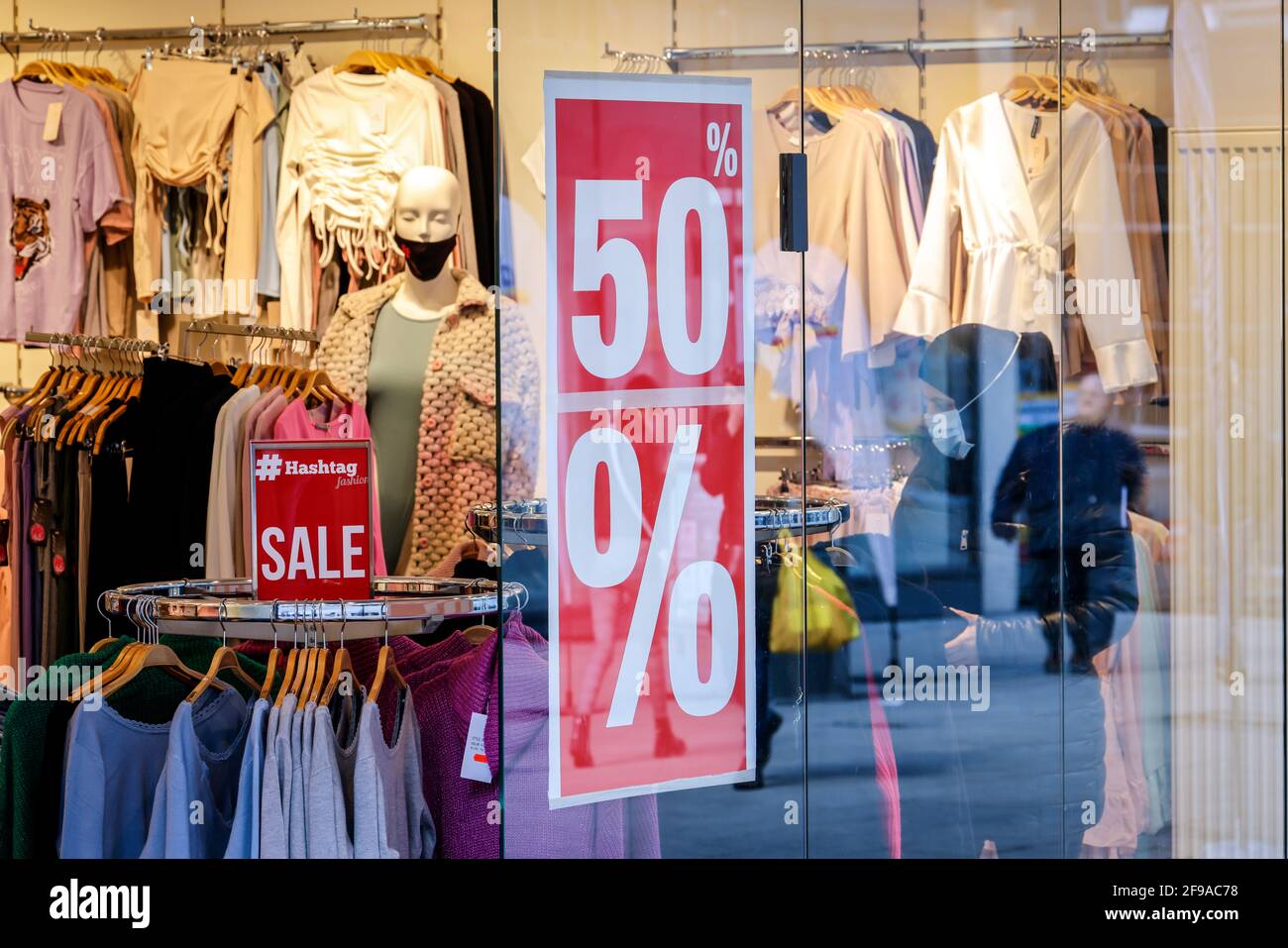 Essen, North Rhine-Westphalia, Germany - discount battle in the corona crisis, retail sales in times of the corona pandemic at the second lockdown, shops in NRW are partially open subject to conditions, Click & Meet, register online and make a shopping appointment, poster in the shop window Reduced, 50 percent discount. Stock Photo