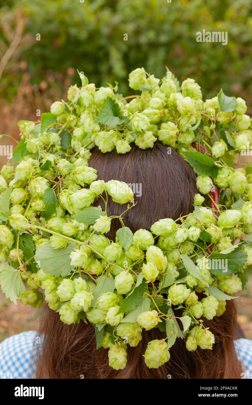 Woman with a wreath of hops on her head Stock Photo