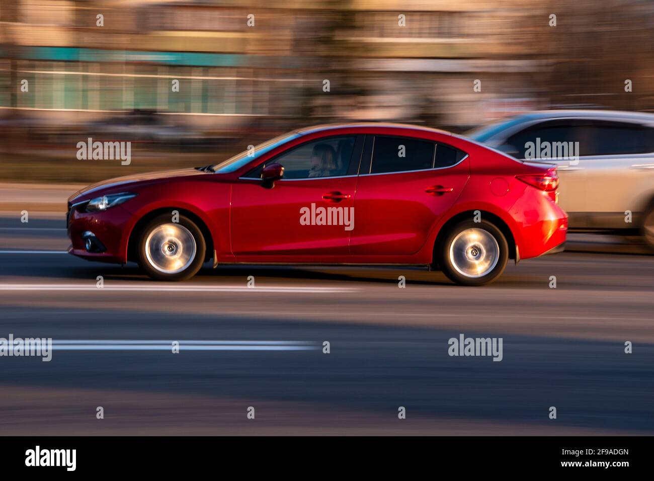 Ukraine, Kyiv - 11 March 2021: Red Mazda 3 car moving on the street; Stock Photo