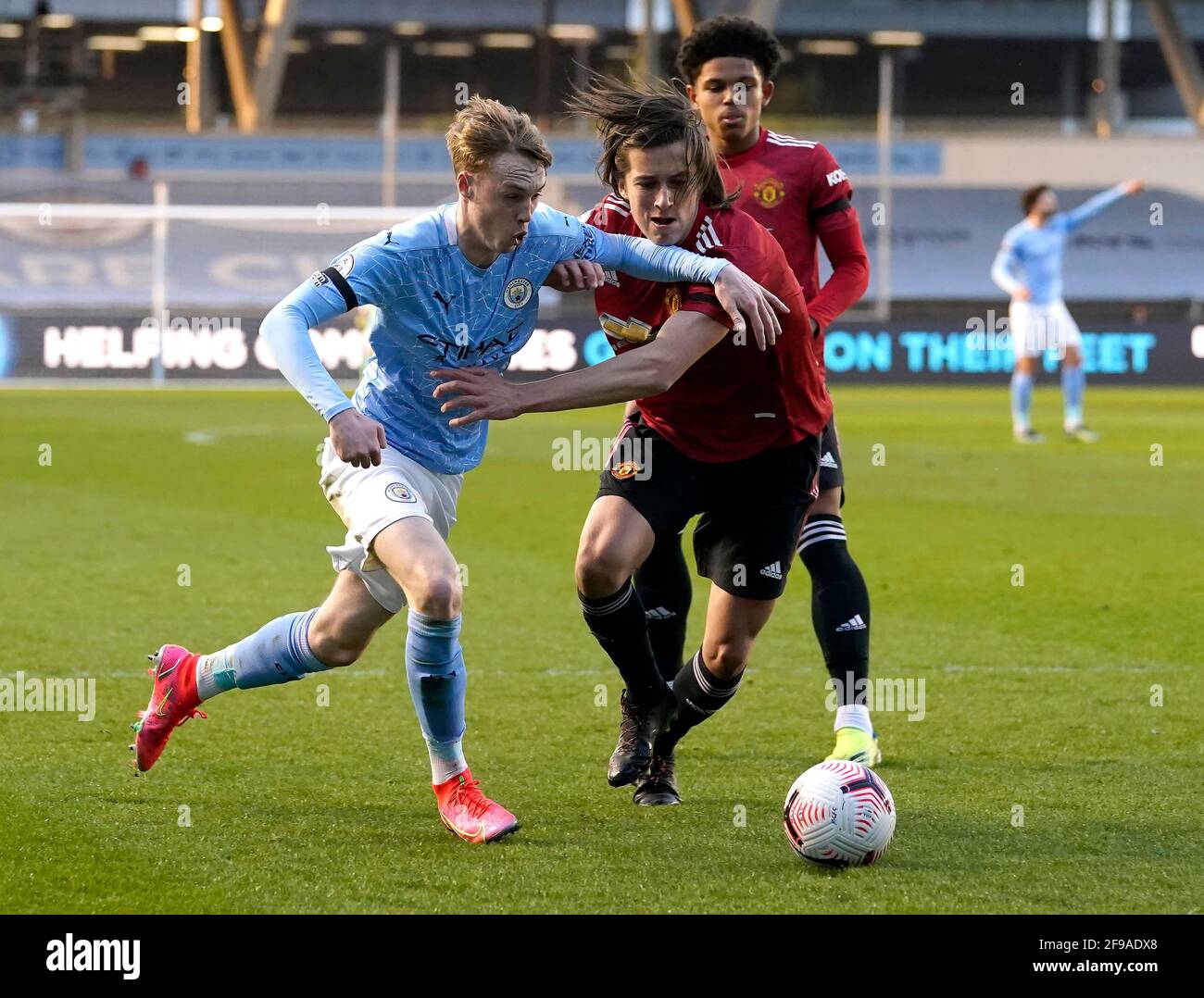 Manchester, England, 16th April 2021. Cole Palmer of Manchester City (L) holds off Alvaro Fernandez of Manchester United  during the Professional Development League match at Academy Stadium, Manchester. Picture credit should read: Andrew Yates / Sportimage Stock Photo