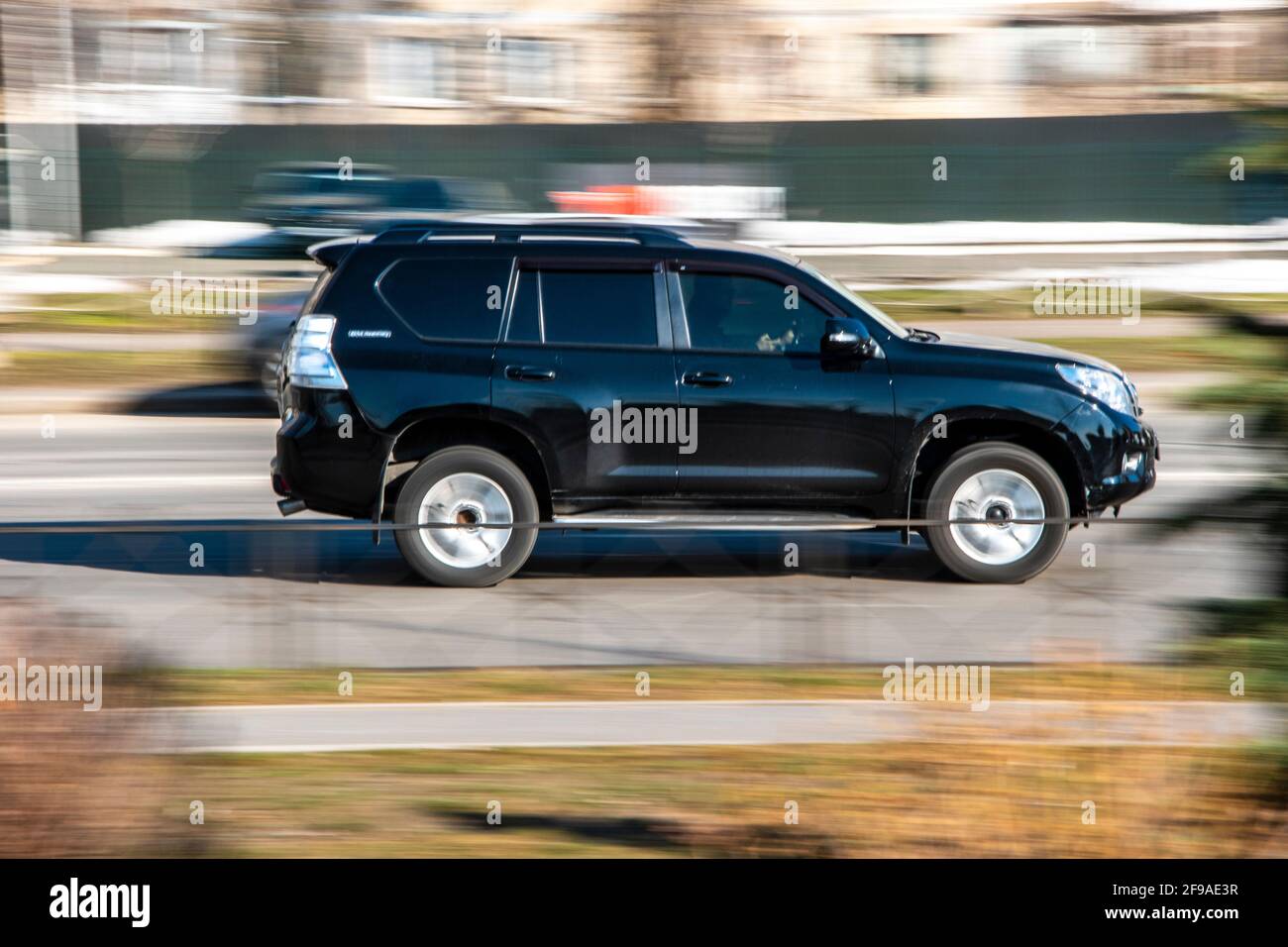 Ukraine, Kyiv - 11 March 2021: Black Toyota Land Cruiser Prado car moving on the street; Stock Photo