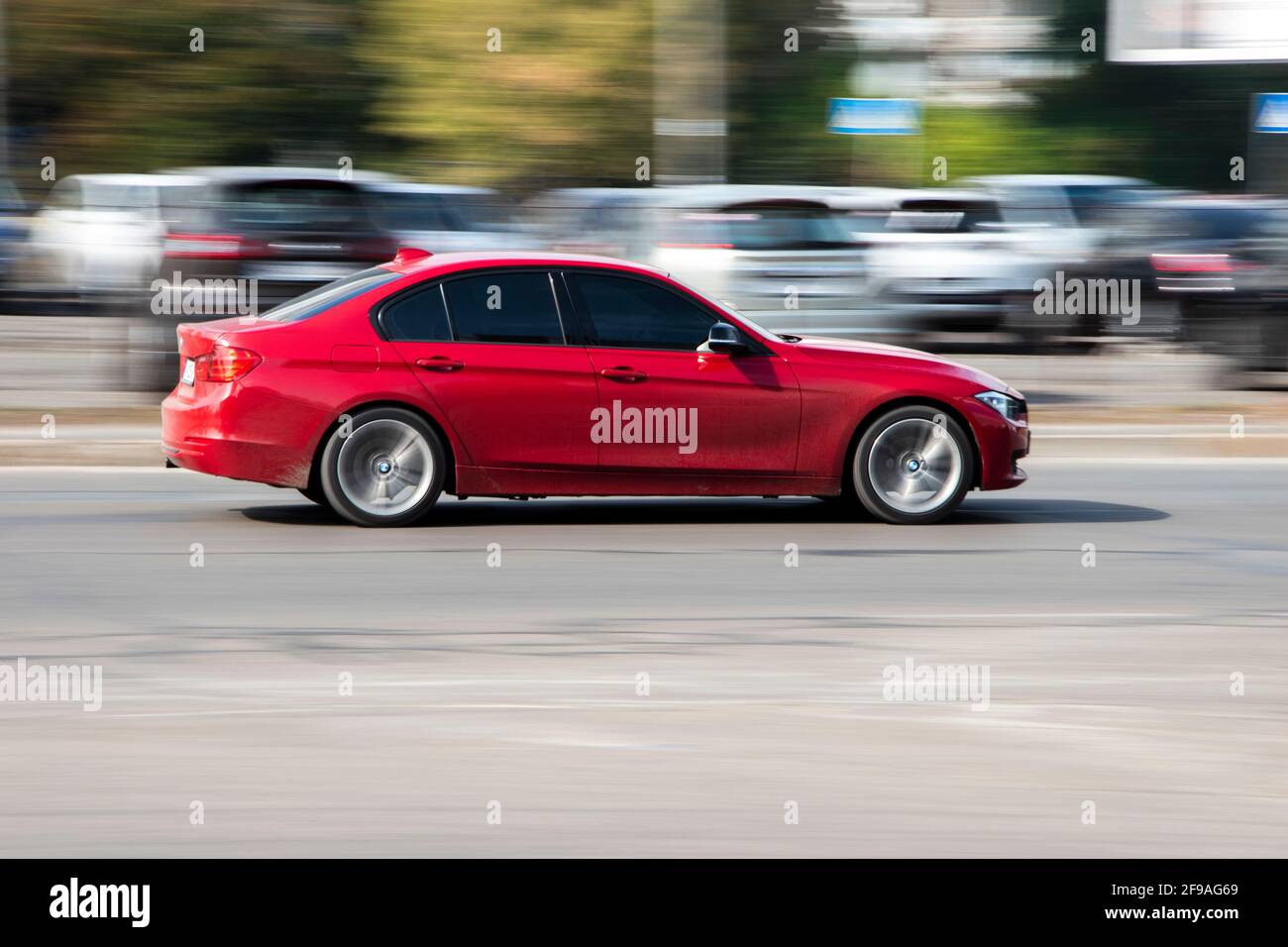 Ukraine, Kyiv - 1 October 2020: Red BMW 3 Series car moving on the street Stock Photo