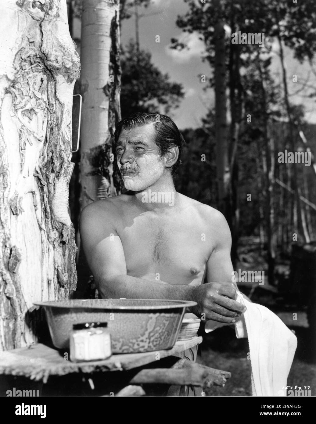 CLARK GABLE shaving on set location canid in Colorado during filming of ACROSS THE WIDE MISSOURI 1951 director WILLIAM A. WELLMAN screenplay Talbot Jennings book Bernard DeVoto Metro Goldwyn Mayer Stock Photo