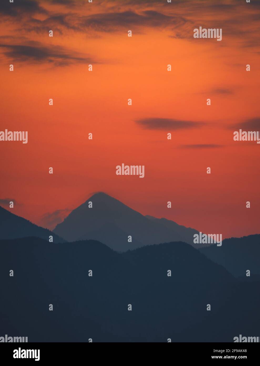 Sunrise behind big mountain silhouette lake bled Slovenia alps Stock Photo