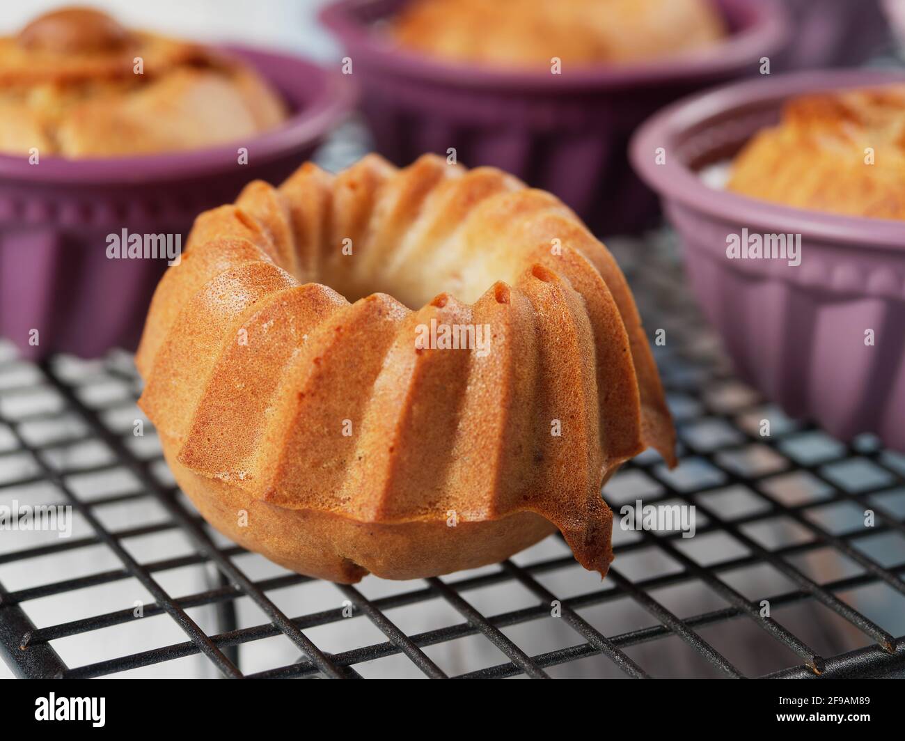 Homemade banana mini bundt cakes on a cooling rack. No sugar added. Healthy toddler food Stock Photo