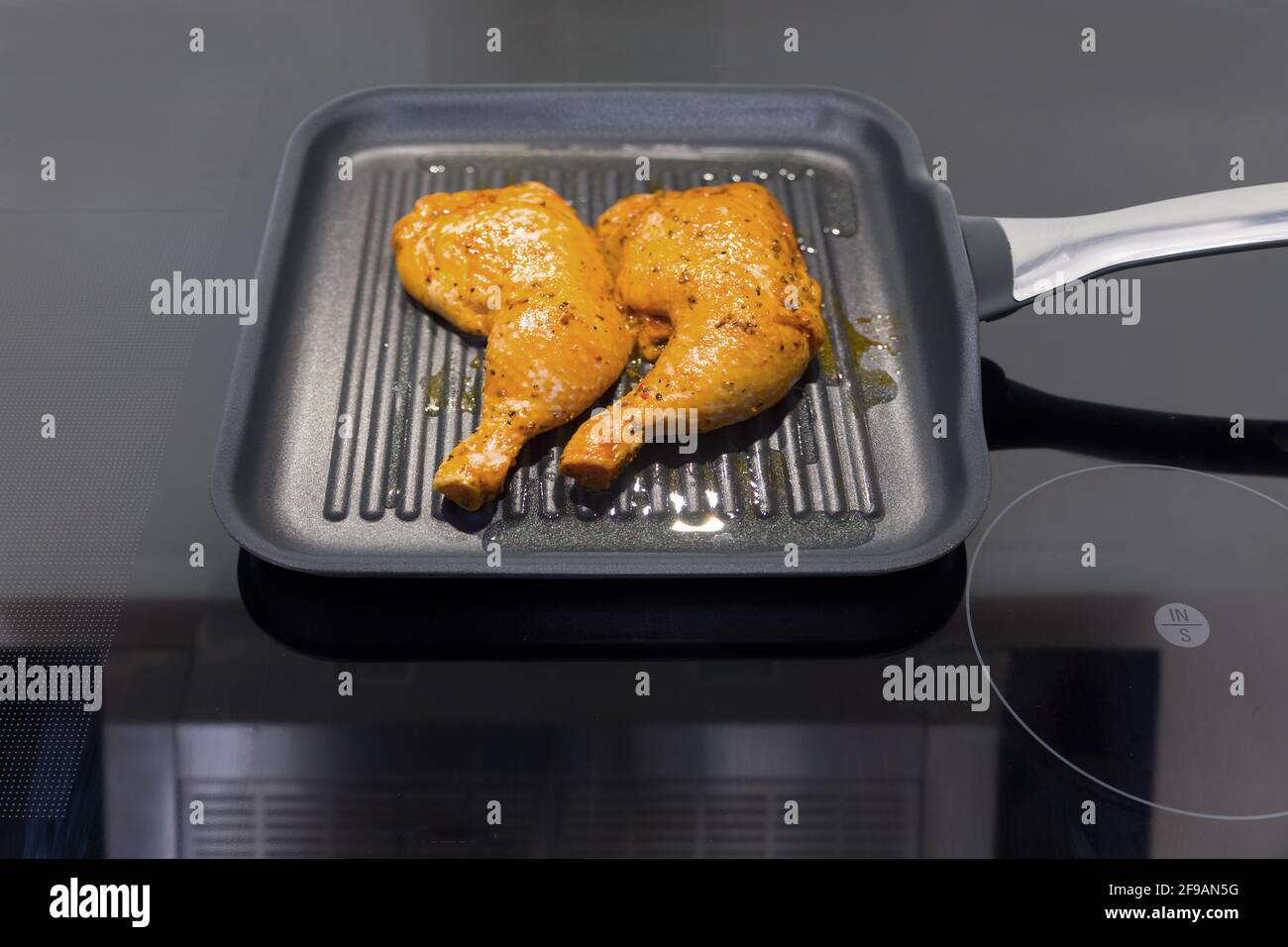 Two chicken legs in a frying pan Stock Photo