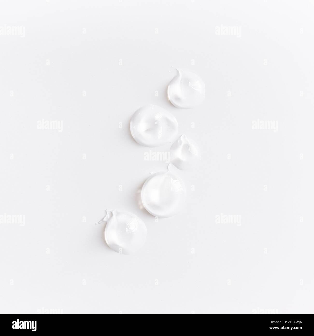 Textures from cosmetics. Smears from transparent body cream on white table Stock Photo