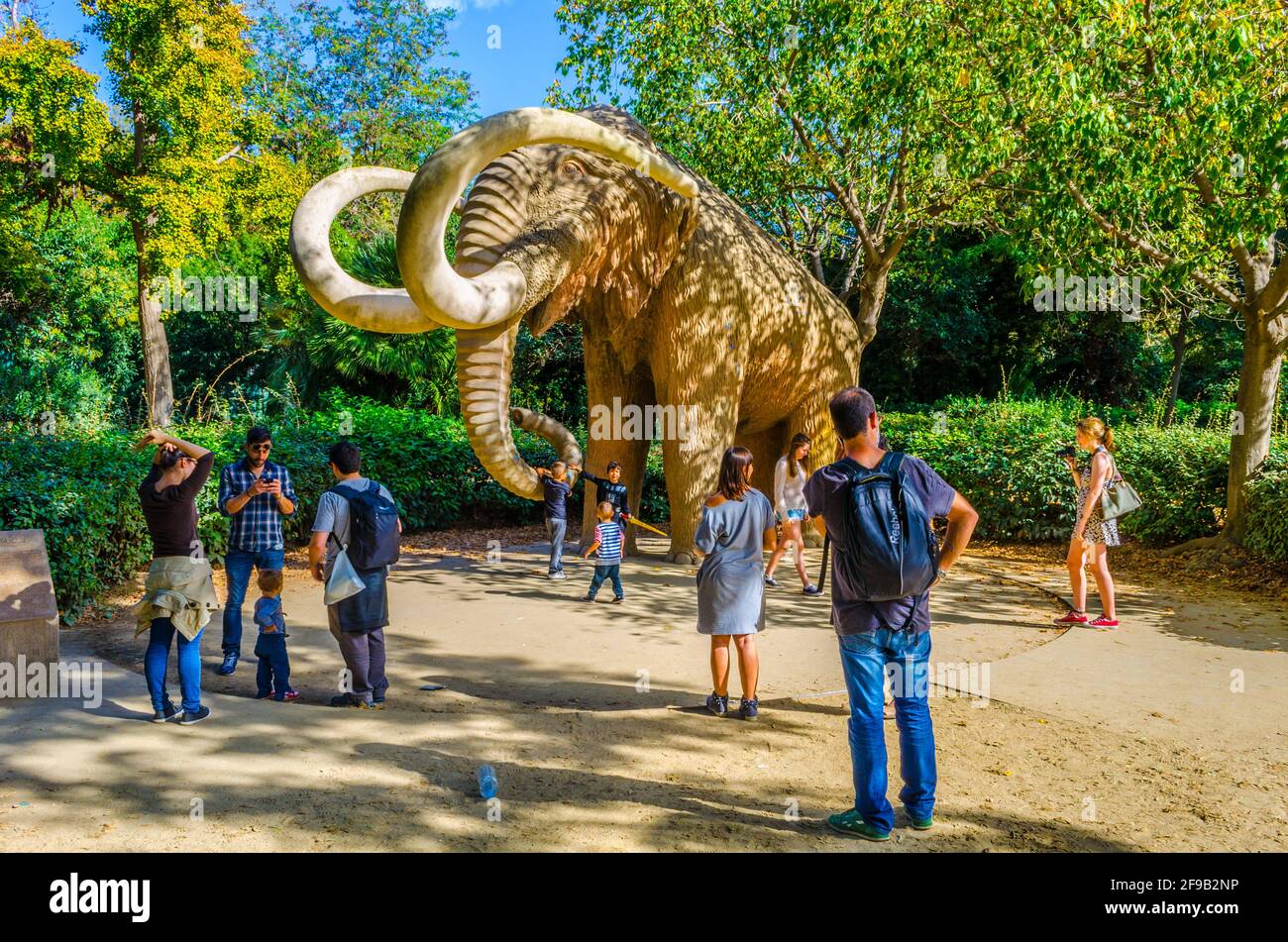 BARCELONA, SPAIN, OCTOBER 26,2014: People are passing Mammoth statue in the ciutadella park Barcelona, Spain. Stock Photo