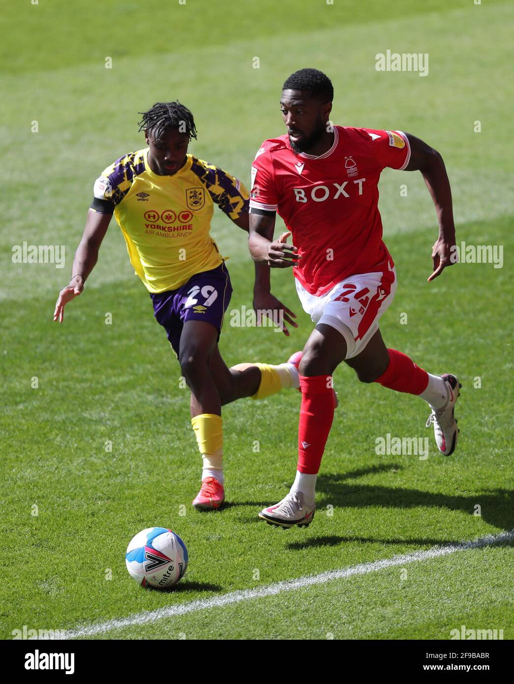 Nottingham Forest's Tyler Blackett and Huddersfield Town's Aaron Rowe (left) battle for the ball during the Sky Bet Championship match at City Ground, Nottingham. Picture date: Saturday April 17, 2021. Stock Photo