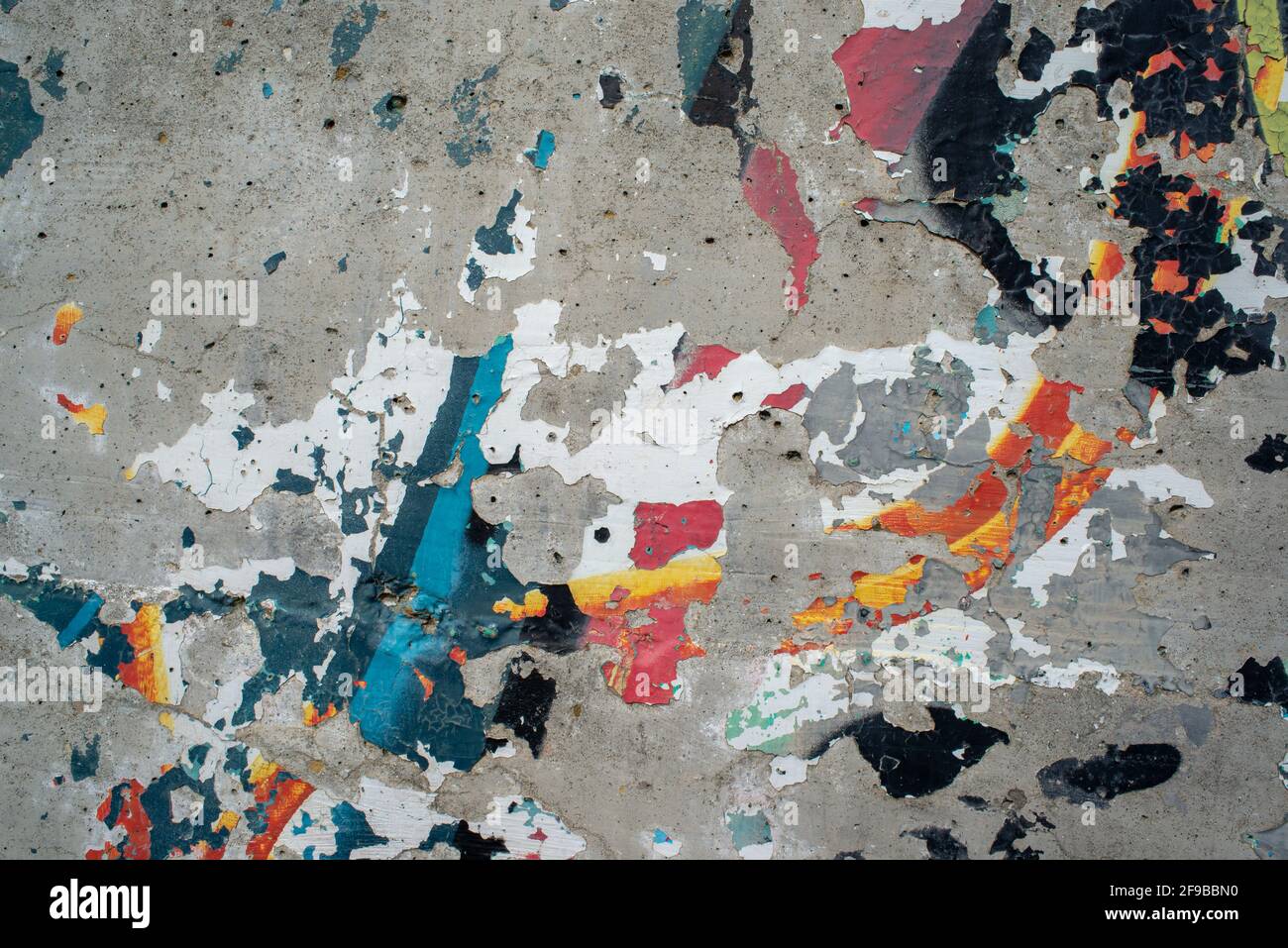 Old wall texture background, peeling cracked paint of different colors seamless pattern and abstract shapes Stock Photo