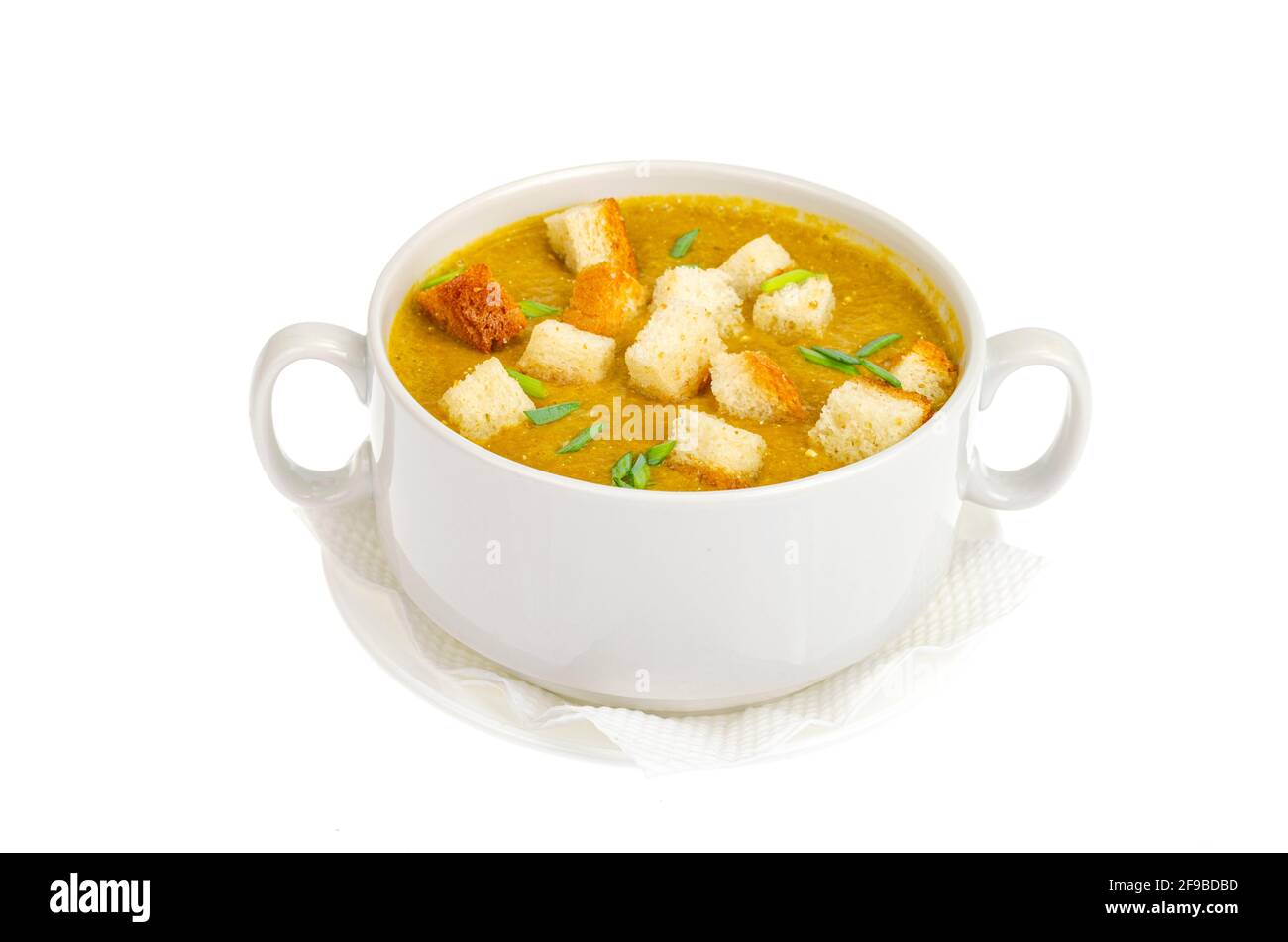 Vegetable cream soup with wheat croutons in bowl isolated on white ...