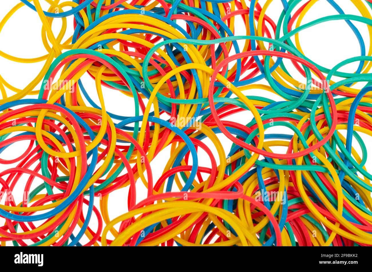 Many colourful multi coloured elastic rubber bands on white background
