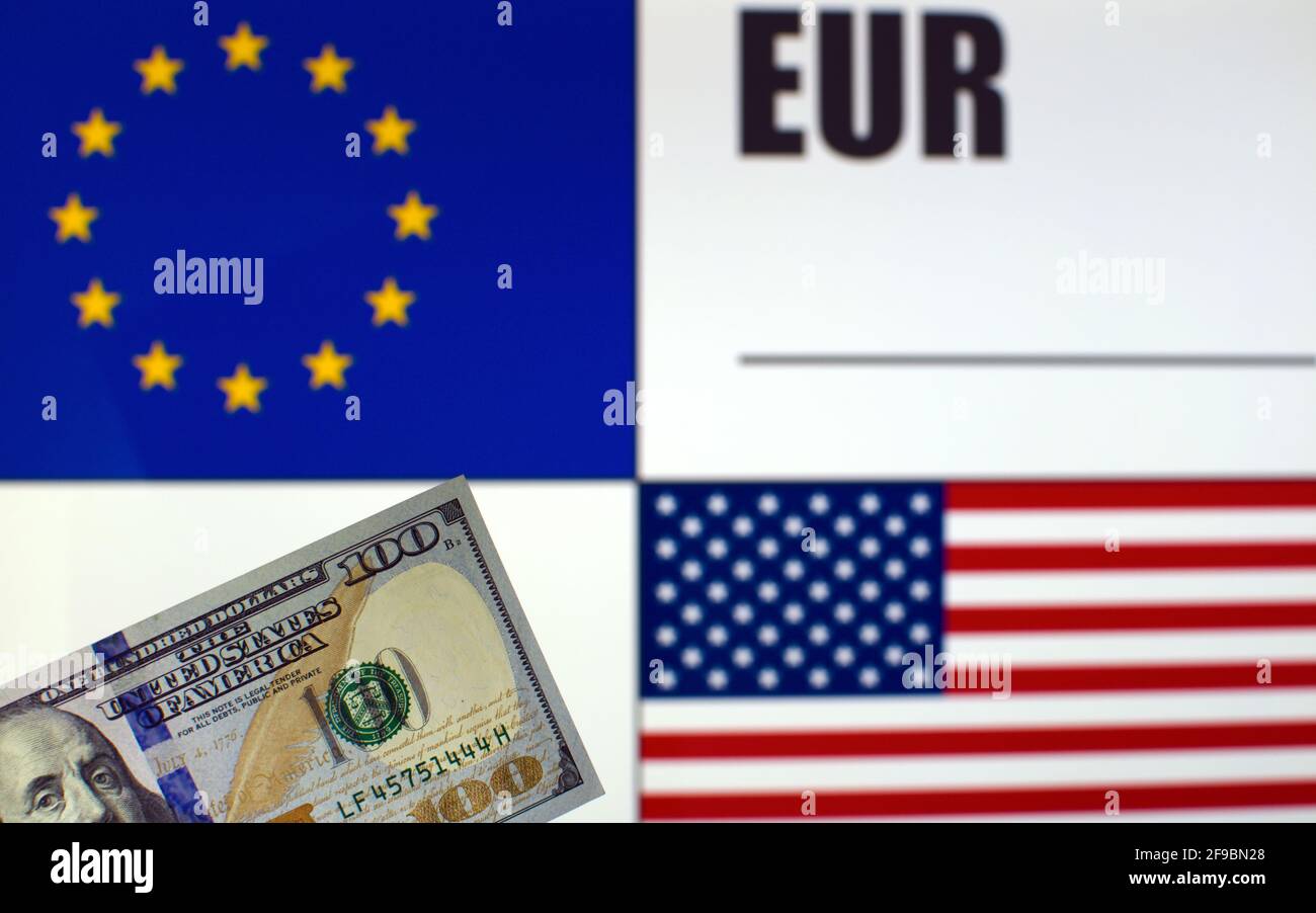 100 US dollars banknote on blurred background of EU and US flags and EU currency code. Exchange rate template Stock Photo