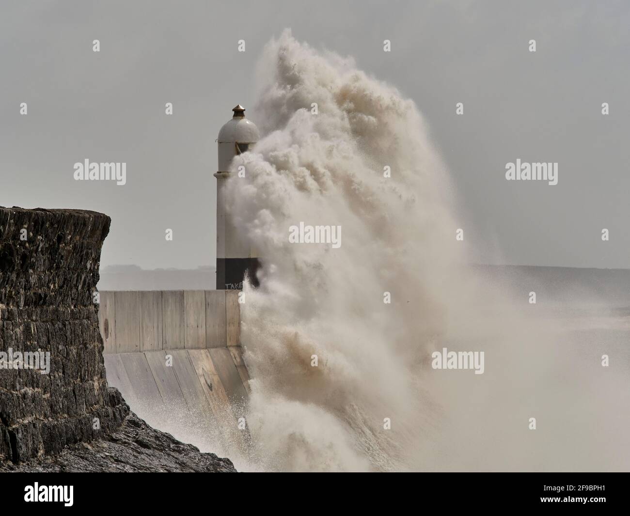 High waves during storm, Porthcawl lighthouse, South Wales, UK. Stock Photo