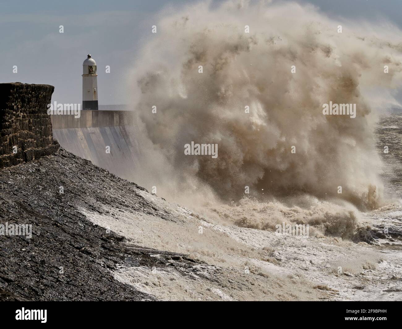 High waves during storm, Porthcawl lighthouse, South Wales, UK. Stock Photo