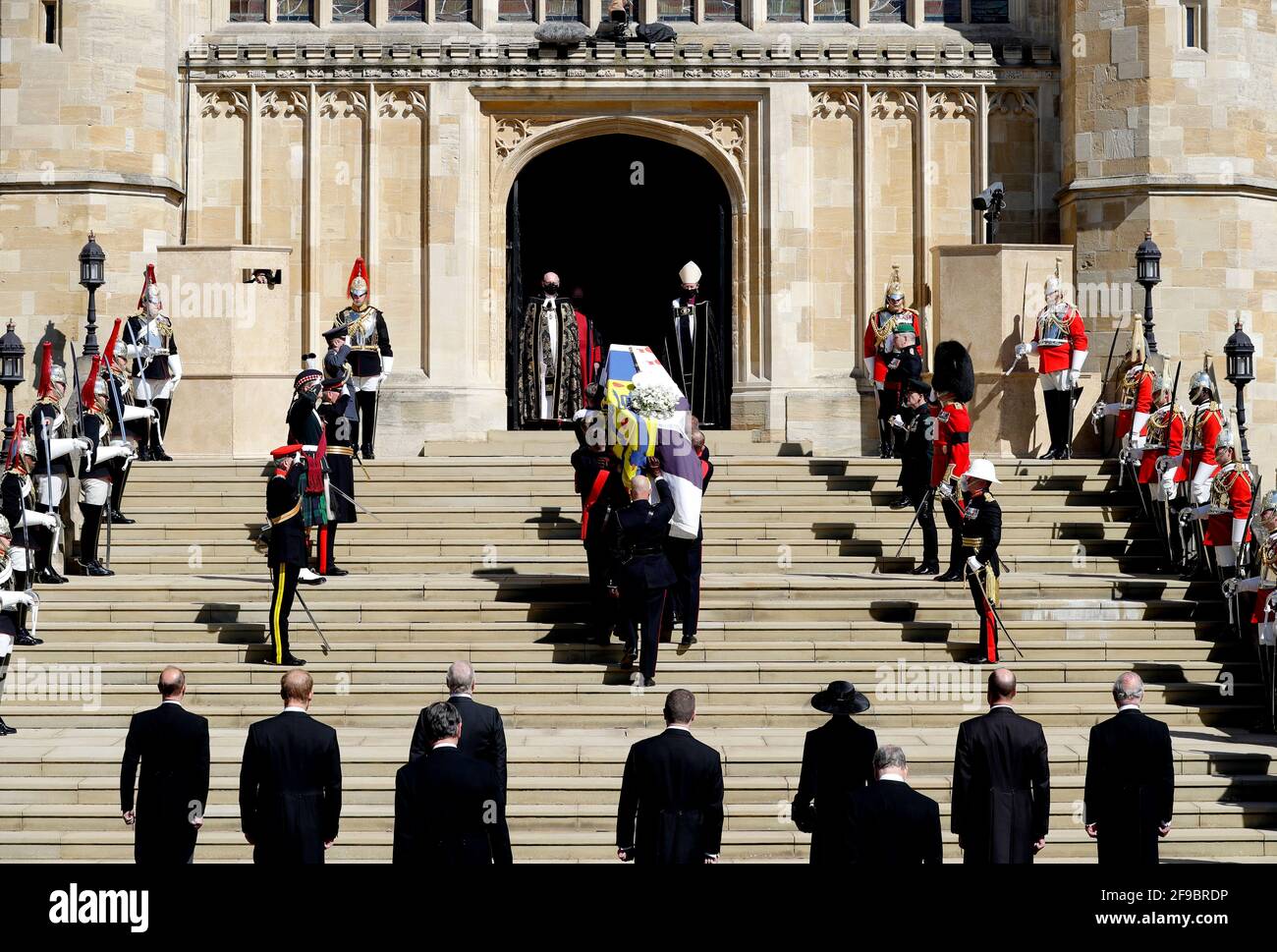The Duke of Edinburgh's coffin, covered with His Royal Highness's Personal Standard is carried into St George's Chapel, Windsor Castle, Berkshire, followed by the Prince of Wales, the Duke of Cambridge, the Princess Royal, the Earl of Snowdon, Vice-Admiral Sir Timothy Laurence, the Earl of Wessex, the Duke of Sussex and the Duke of York during the funeral of the Duke of Edinburgh. Picture date: Saturday April 17, 2021. Stock Photo
