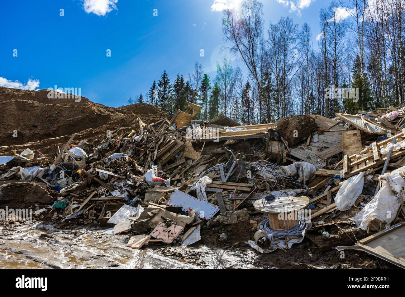 Landfill of construction waste and garbage in nature. Environmental pollution. Illegal construction waste dump Stock Photo
