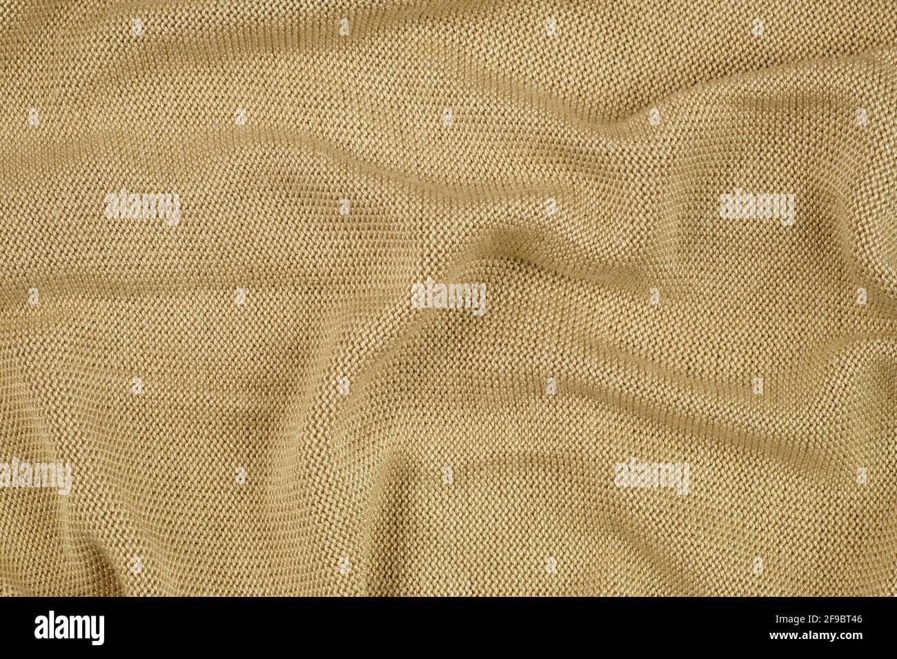 Beige delicate knit. A draped surface of clothing Stock Photo Alamy