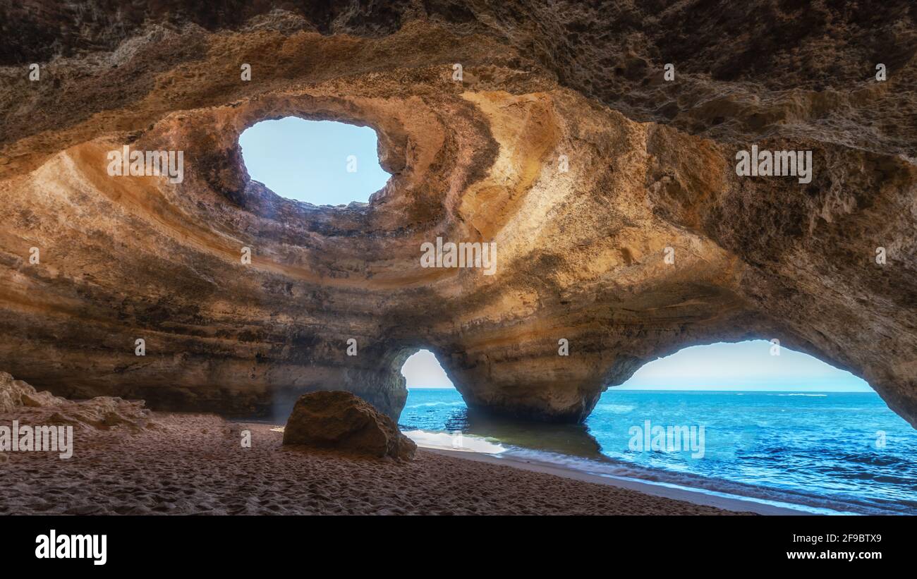 Inside view of the famous natural sea cave during sunrise in Benagil ...