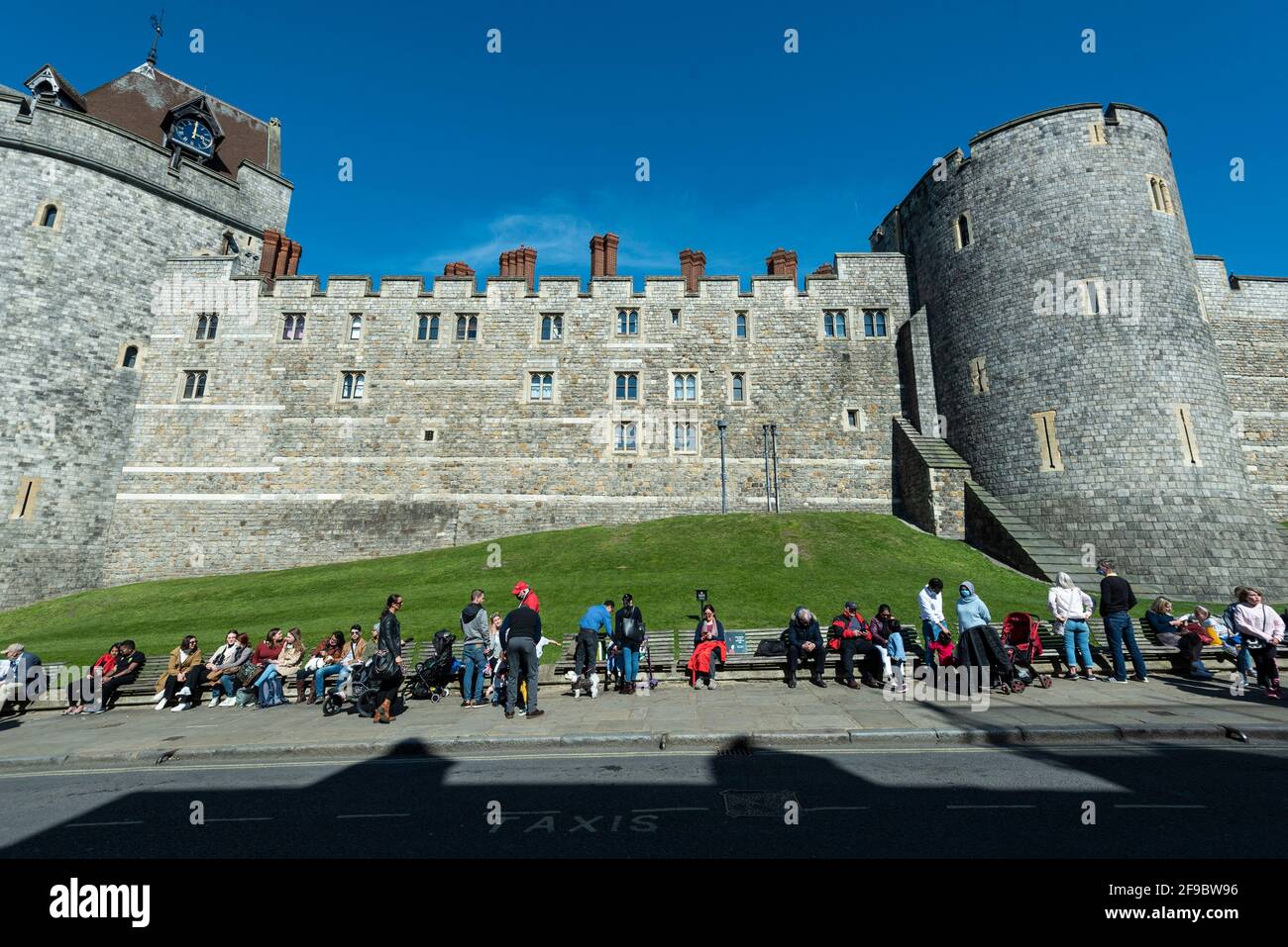 Windsor, UK. 17 April 2021. A clock shows 3pm on Windsor Castle, marking the start of a 2 minute silence, as crowds gather outside Windsor Castle on the day of the funeral of Prince Philip who died on 9 April, aged 99. Coronavirus pandemic restrictions have limited the number of mourners to 30 close family members at the 3pm funeral at Windsor Castle. Credit: Stephen Chung / Alamy Live News Stock Photo