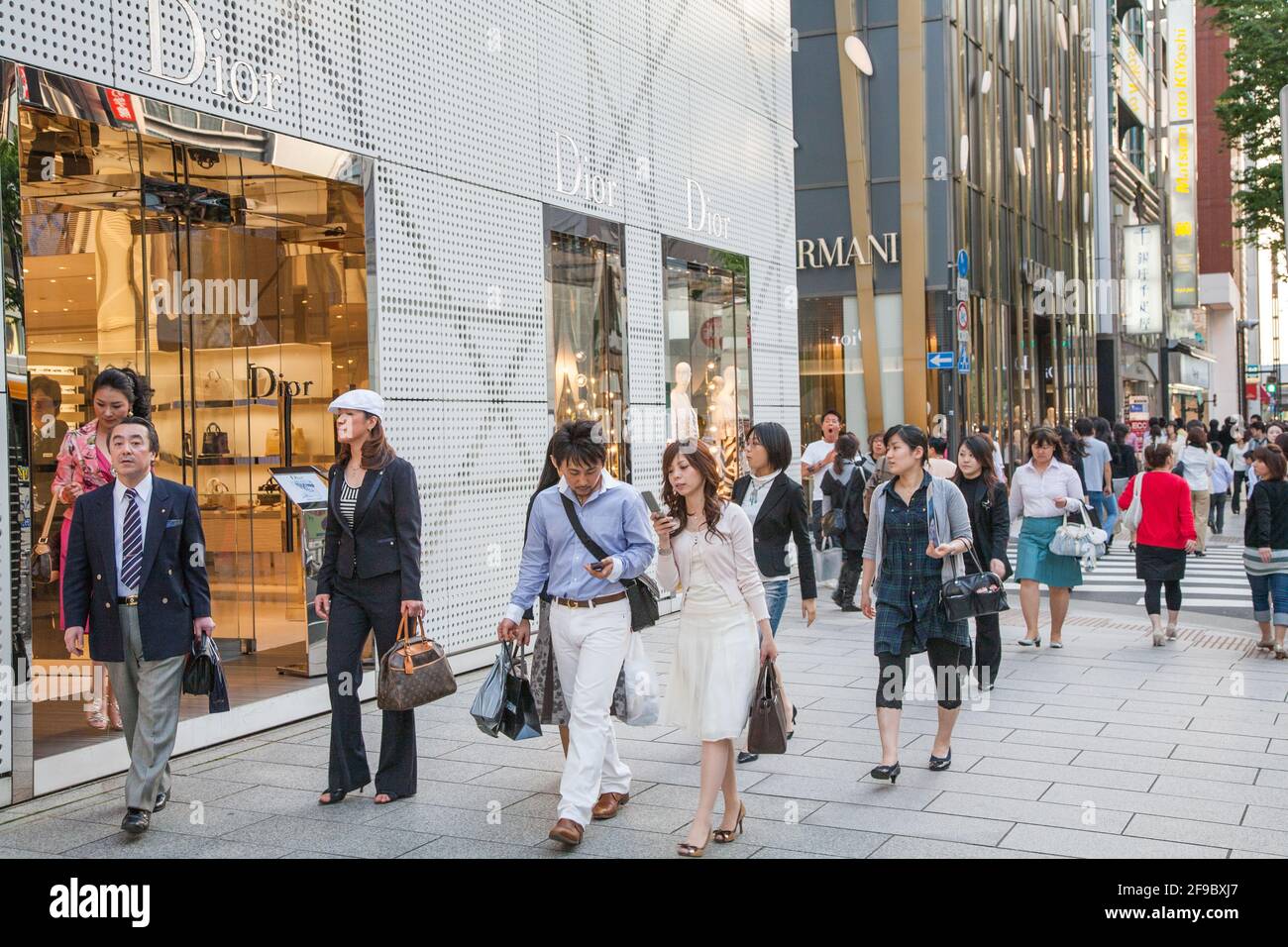 Japanese public passing by Dior and Armani stores in Ginza, Tokyo, Japan Stock Photo