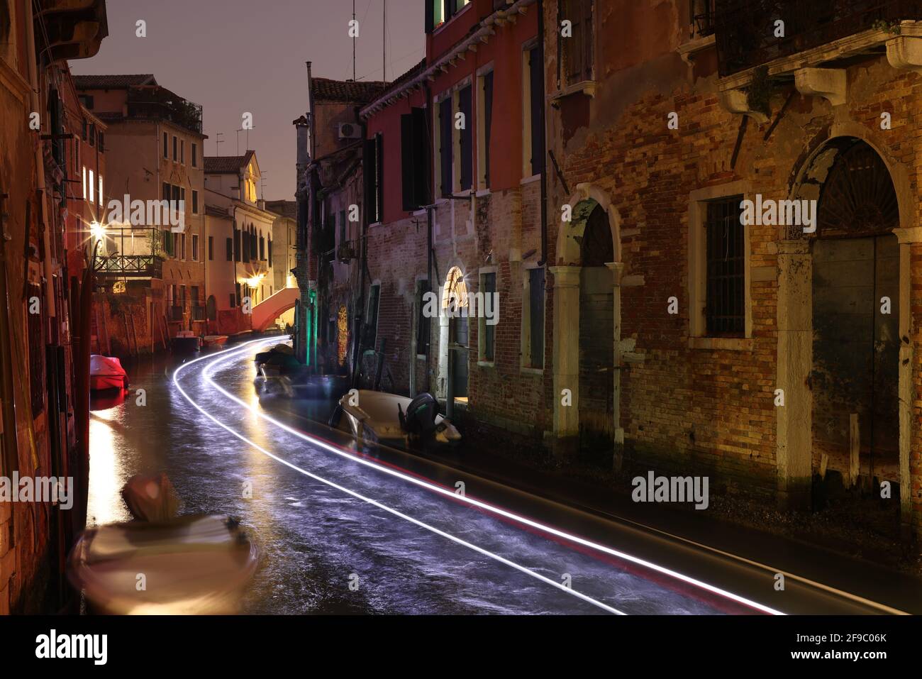 Venice, light trails of a boat on the canal in the sestiere Castello, Italy Stock Photo