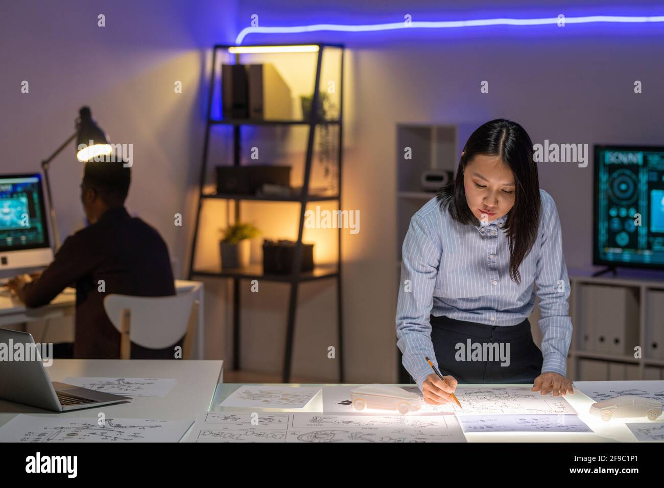 Concentrated young Asian designer in 