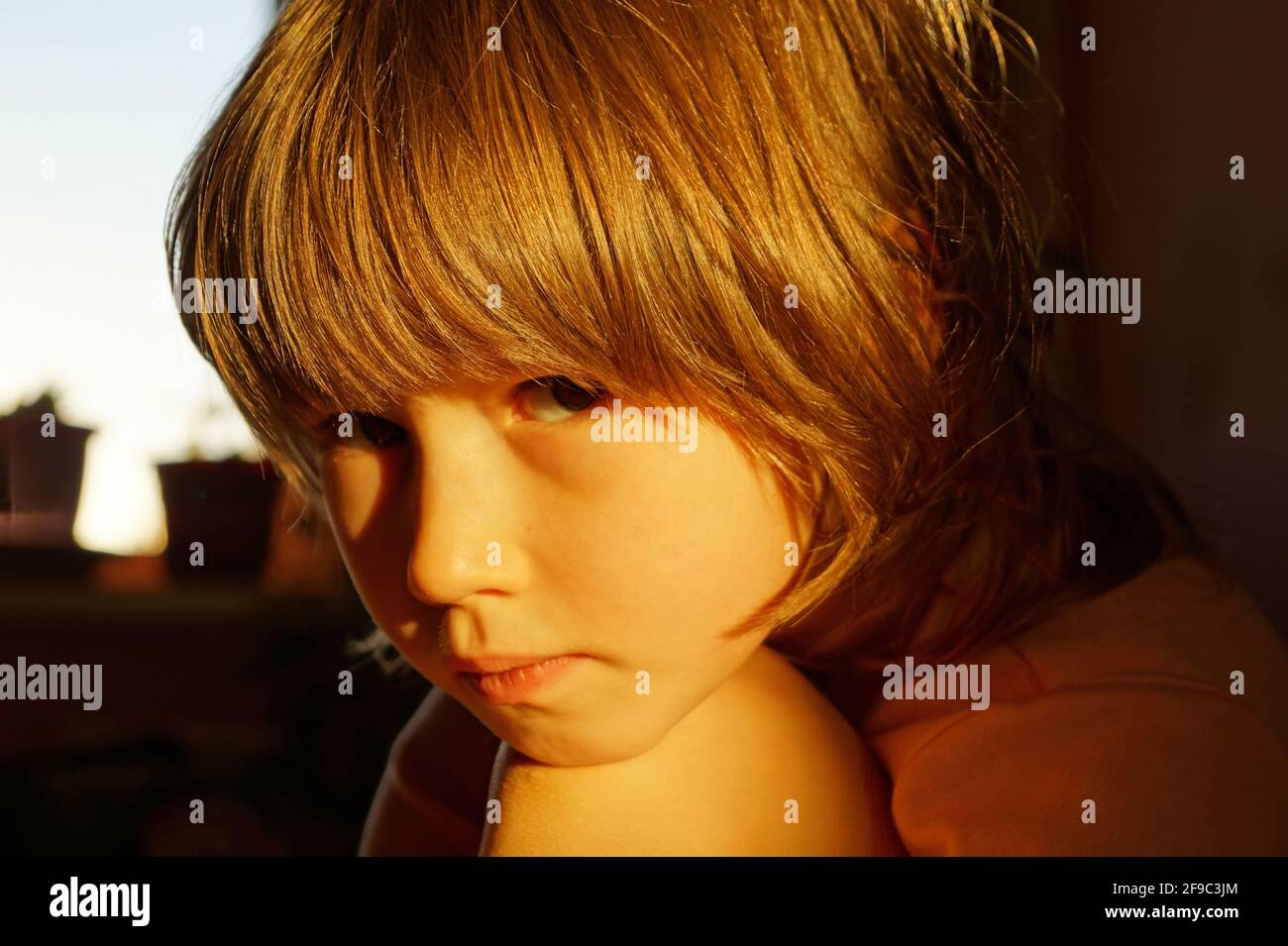 A 5-10 year old girl looks at the camera Stock Photo