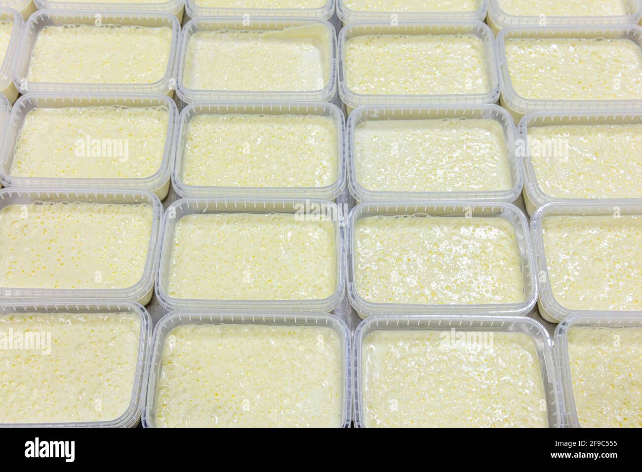 Milky cream wavy surface. Closeup. Milk cream layer texture. Clotted