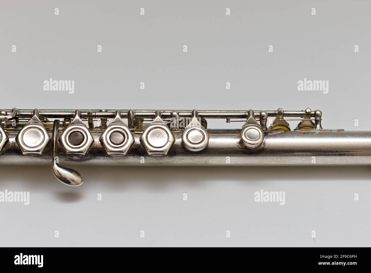 Silvery musical instrument with keys on a white background with soft ...