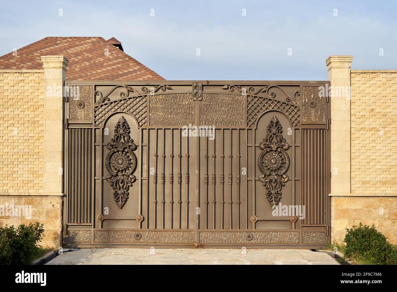 Large metal gates and a high fence Stock Photo