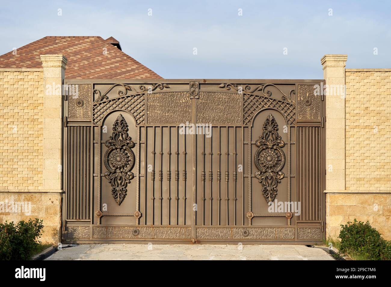 Large metal gates and a high fence Stock Photo - Alamy