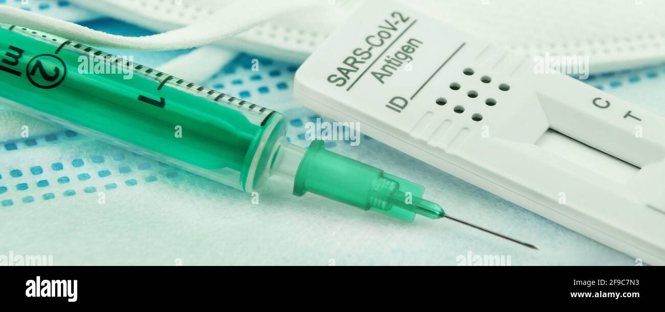 Corona Antigen Rapid Test and Vaccination with mask Stock Photo