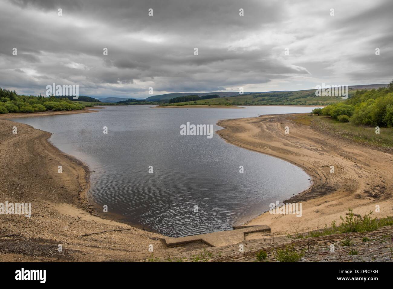 Low water level on a UK reservoir. Fly fishing in drought conditions at