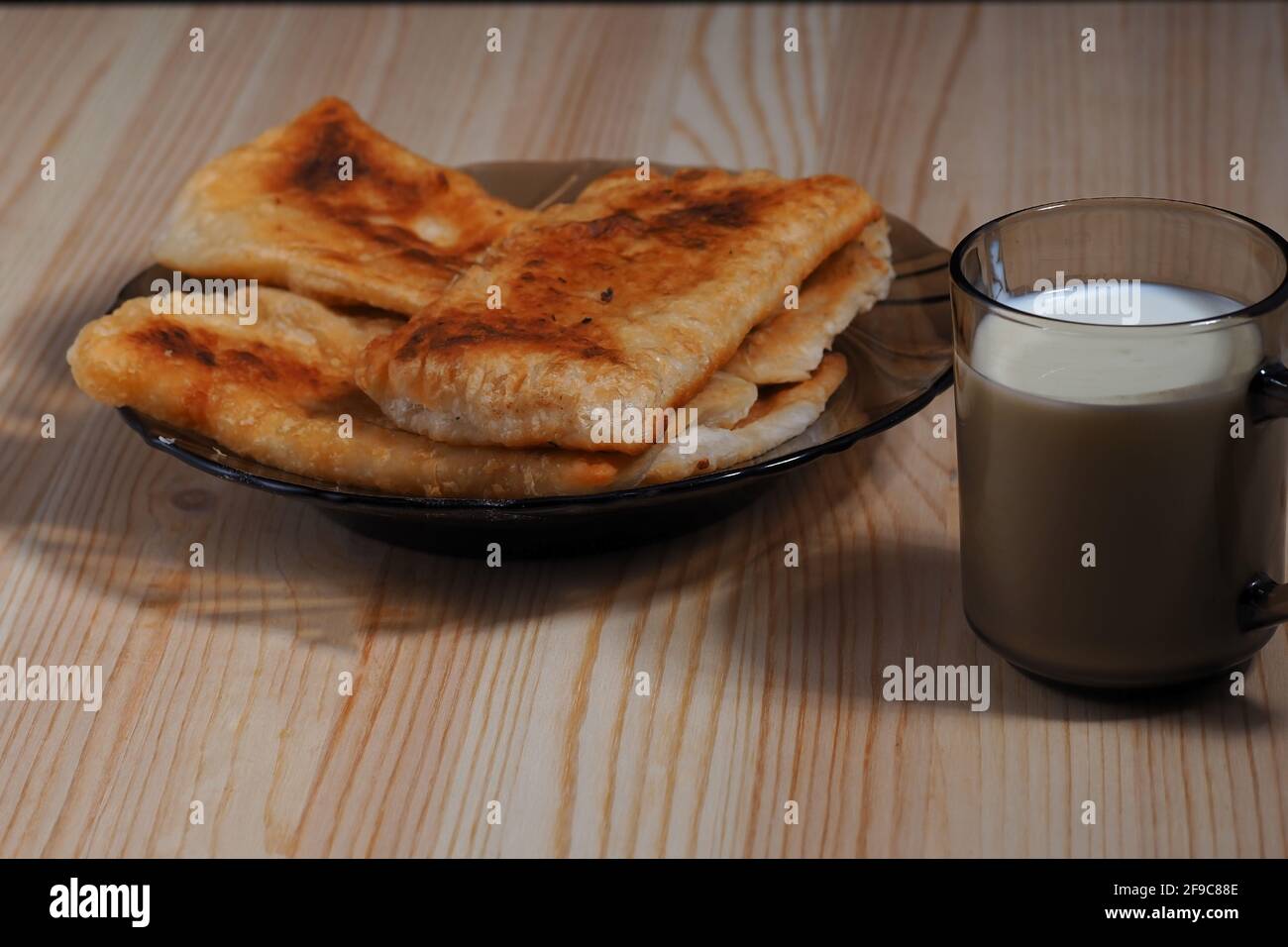 Homemade food. Pies and a glass of milk on the table. Stock Photo